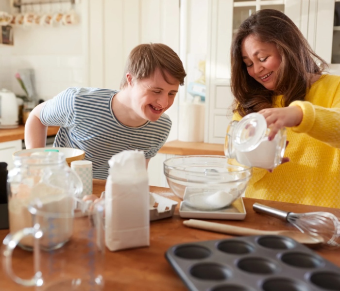 NDIS support worker providing meal preparation support to participant